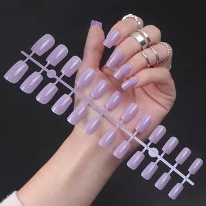 Glossy lavender square long fake nails with UV top coat on purple display rack