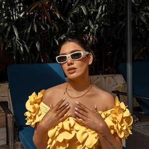 Detail of 3D floral petals on a bright yellow bandeau swimsuit with elegant textures