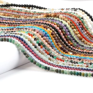 Multiple strands of 2mm and 3mm round natural stone beads in assorted vibrant colors