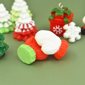Macro shot of miniature resin Christmas tree, gloves and gift box for DIY crafts
