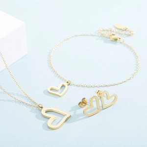 Detailed view of a gold hollow heart jewelry set featuring necklace, bracelet and earrings