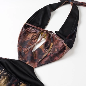 Detail of mesh dress featuring halter neck, chest cutout and gold metal ring hardware