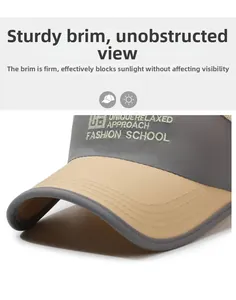 Detail of grey sun visor hat featuring unique embroidered letters and sturdy brim texture