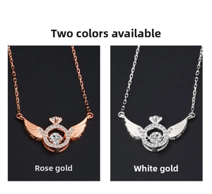 Detail of angel wing pendant necklaces in rose gold and silver with dancing stone center