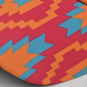 Macro view of colorful geometric diamond pattern fabric on women's ponytail cap