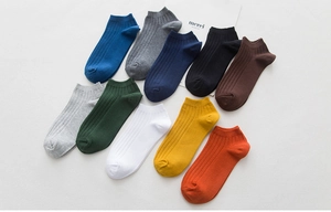 Flat lay of breathable cotton ankle socks in 10 diverse colors with ribbed knit texture