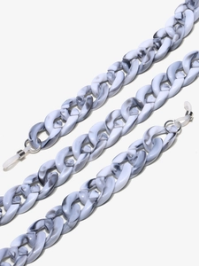 Close-up of marble-textured acrylic eyewear chains with metallic links and silicone tips