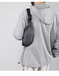 Close-up of black crossbody chest bag with durable nylon texture and heavy-duty buckle