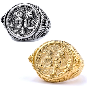 Close-up of vintage embossed mythic totem and figures on gold and silver steel rings