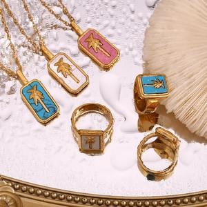 Detail of 18K gold-plated jewelry with colorful coconut tree tropical shell charms