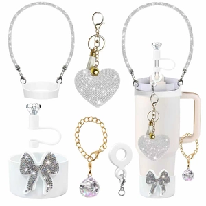 Detail of glittery heart keychain, diamond straw cap and hand rope for Stanley cups