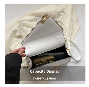 Internal view of white faux leather crossbody bag showing space for phone and wallet