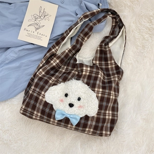 Close-up of brown plaid tote bag with cute white puppy plush embroidery and blue bow