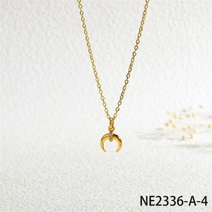 Close-up of golden horn pendant necklace with three inlaid zircons on a white textured background