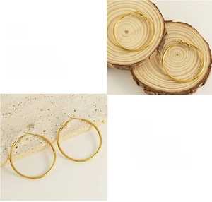 Detailed view of 18K gold plated hoop earrings with polished finish and shiny texture