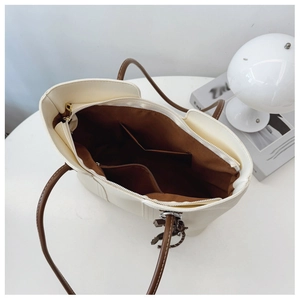 Macro shot of spacious tote interior with dark lining, zip pocket, and compartments