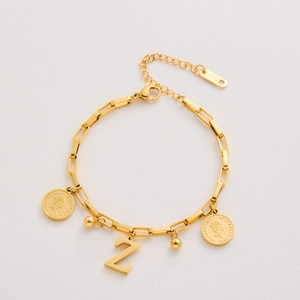 Close-up of gold stainless steel bracelet with Elizabeth II coin and letter Z charm