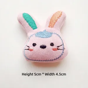 Pink plush rabbit charm with detailed embroidery and contrast color ears, 5cm x 4.5cm size