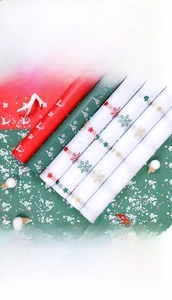 Christmas wrapping paper with red reindeer and green snowflake prints for holiday gift packing