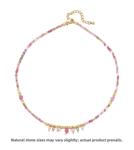 Detail of handmade natural rhodochrosite beaded necklace with golden metal clasp and extension
