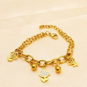 Detail of 18k gold plated hollow flower bracelet with sparkling rhinestones and silk backdrop
