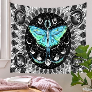 Detail of artistic butterfly tapestry featuring lunar phases and black mandala patterns