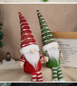 Close-up of red and green knitted Christmas gnomes with long hats and white beards