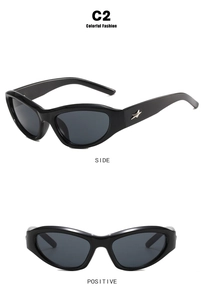 Detail view of black Y2K sunglasses with silver star ornament and dark gray lenses