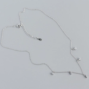 Detailed flat lay of silver S925 sterling silver necklace with sparkling crystal charms