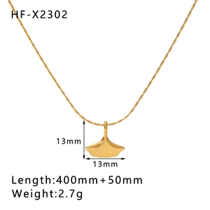 Detail shot of golden ginkgo leaf pendant necklace with size labels and dimensions
