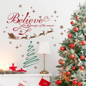 Christmas wall decal with Believe quote, reindeer, and tree on a white living room wall