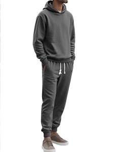 Detail of dark grey tracksuit with textured jacquard pattern on hoodie and joggers