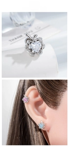 Detailed macro of apple-shaped cartilage studs with heart-cut zirconia and leaf accents