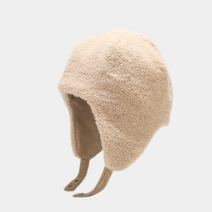 Detail of warm beige corduroy trapper hat with soft faux shearling and snap buckle