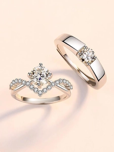 Close-up of S925 silver couple rings with crown setting and sparkling round zircon stone