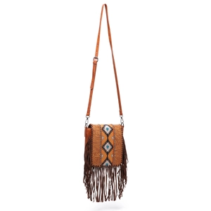 Detail of bohemian crossbody bag featuring vintage fringe, studs and tapestry panel