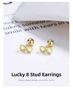 Macro view of infinity symbol stud earrings in gold finish with screw back ball closure