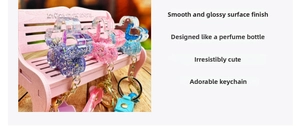 Macro shot of liquid glitter filled star perfume bottle keychains in pink, blue and purple