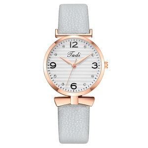 Fashion ladies watch with rose gold bow detail and grey leather strap on white dial