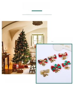 Detailed view of festive Christmas bows with golden bells, green leaves and red berries