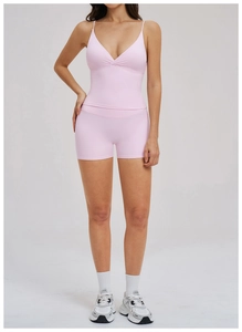 Detailed front view of baby pink yoga set featuring a V-neck tank top and high waist shorts