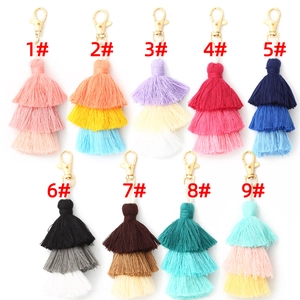 Macro detail of three-layer cotton thread tassels with gold lobster clasp in nine colors