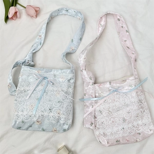 Detail of silk texture shoulder bags with delicate lace, bows and cute bear patterns