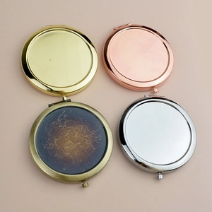 Set of four circular metal folding makeup mirrors in rose gold, gold, silver and bronze