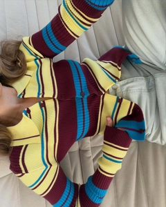 Close-up of retro ribbed knit cardigan with colorful stripes and matching buttons