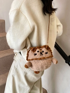 Handmade crochet bear crossbody bag with drawstring closure for women on a model