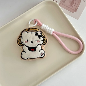 Close-up of cute plush cat keychain with yellow headphones and pink braided rope