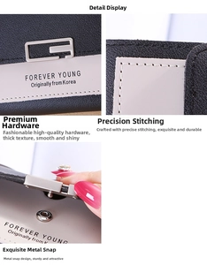 Close-up of contrast stitching, metal G hardware, and snap button on gray leather wallet
