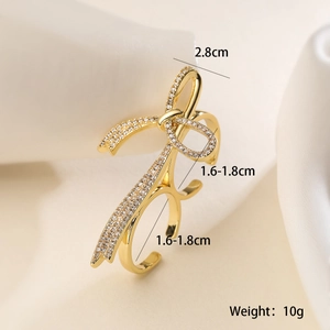 Detail shot of golden bow ring with zircons, showing measurements 2.8cm and 10g weight