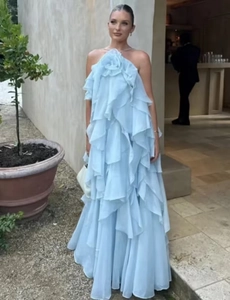 Close-up of light blue halter dress with layered ruffles and 3D floral neckline detail